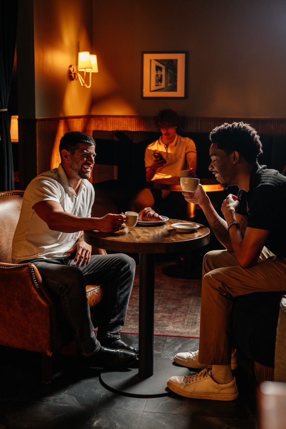 Two guests talking over coffee in the lounge