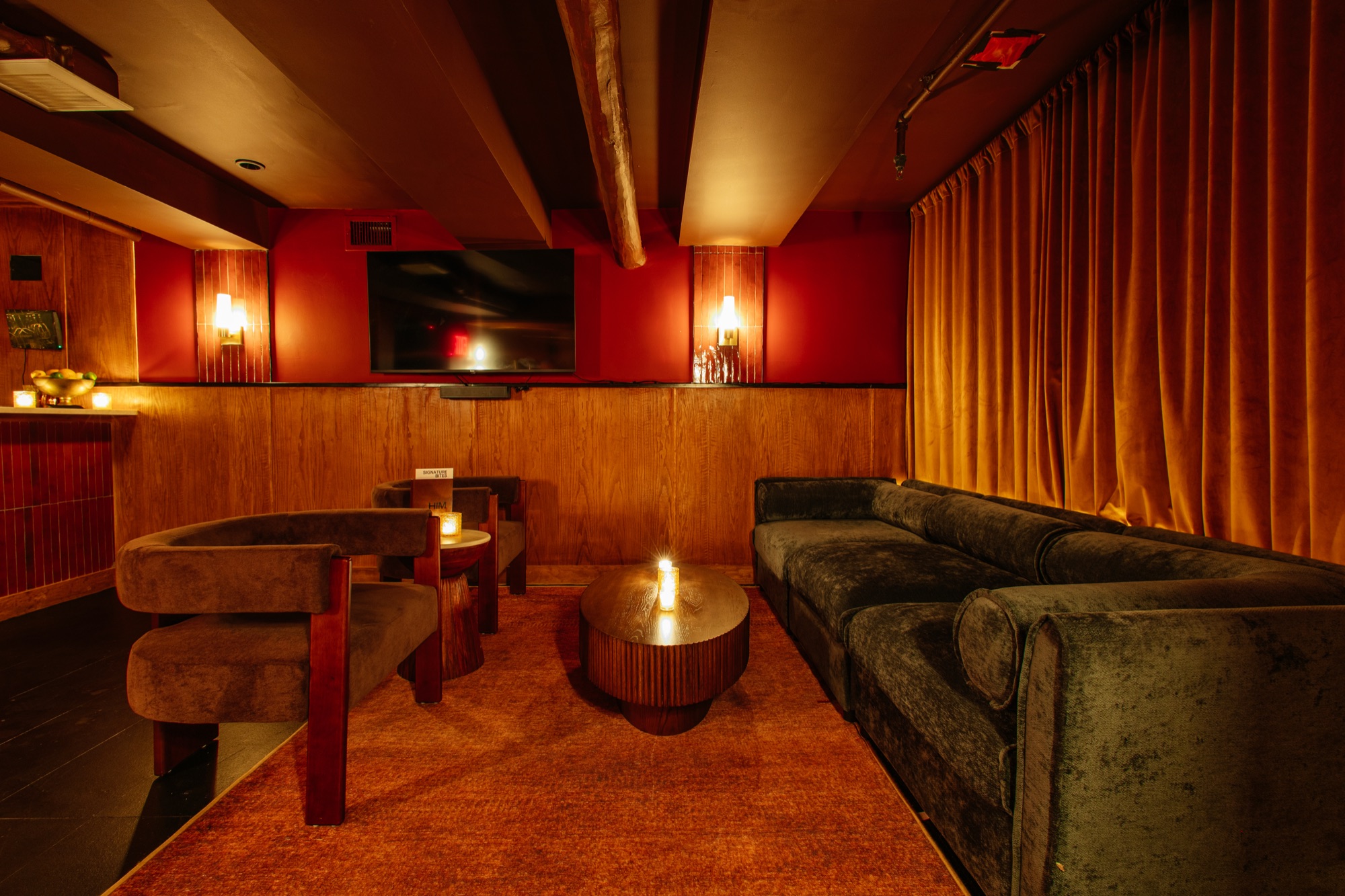A candlelit private room at It's Him, ready for guests