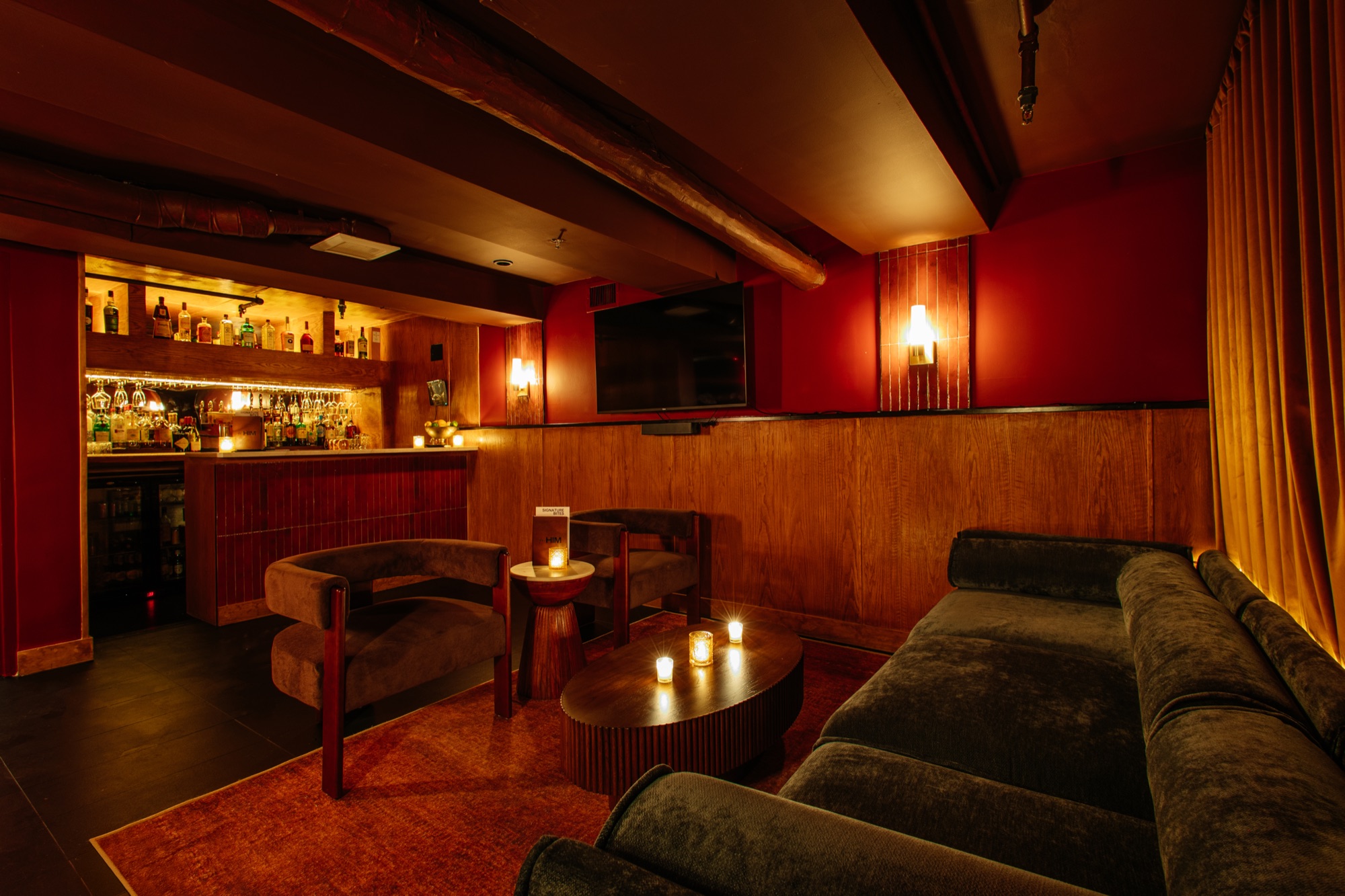 The intimate downstairs bar and velvet lounge of The Den