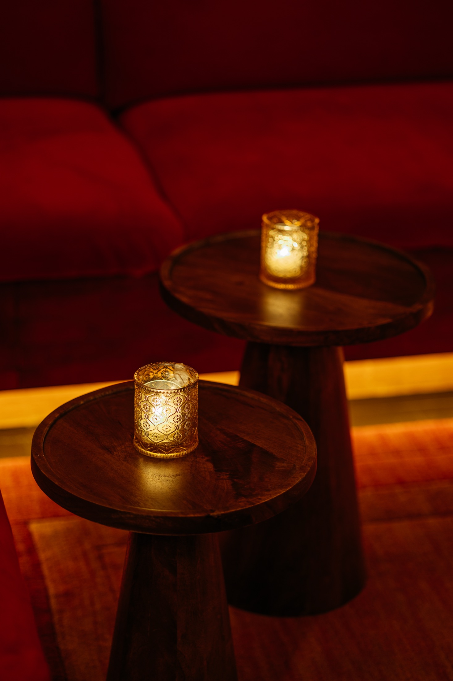 A candlelit booth in The Den