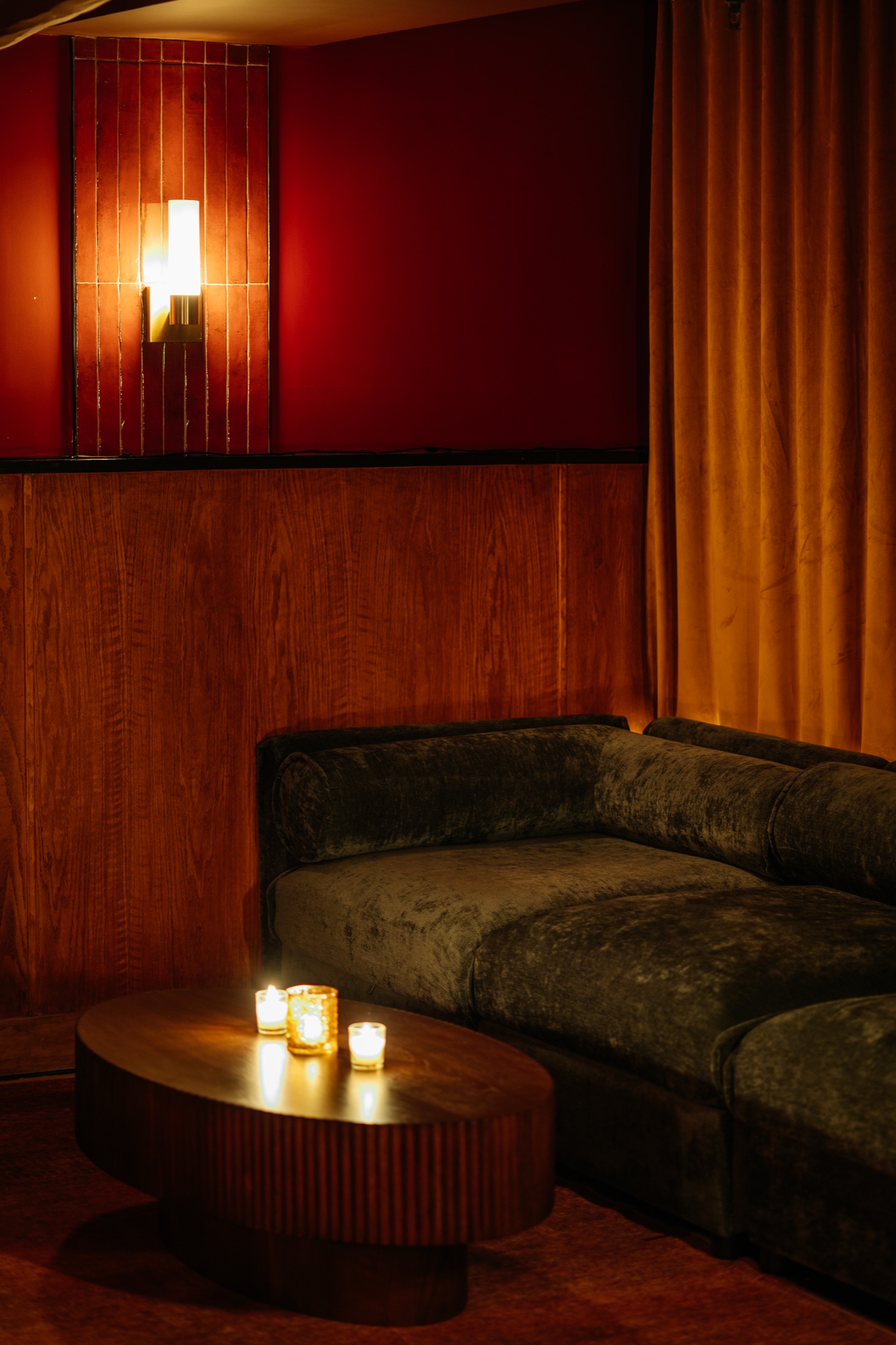Candlelit banquette seating in The Den